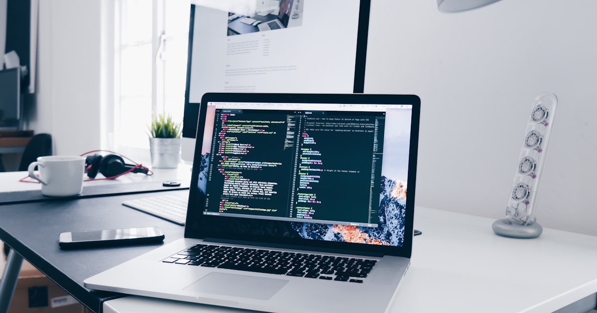 Software engineer working on code at a laptop